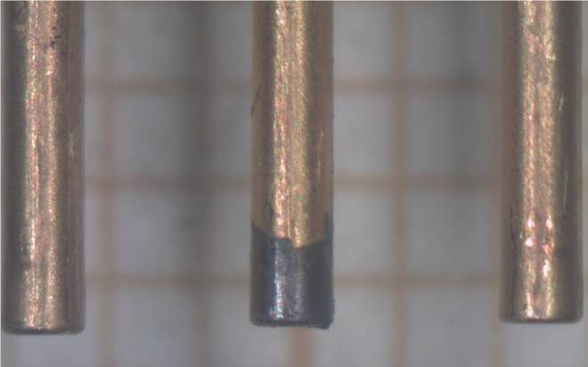 Solder alloy on the end of one terminal.