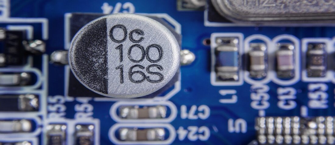 Close up macro of aluminum electrolytic capacitors installed on