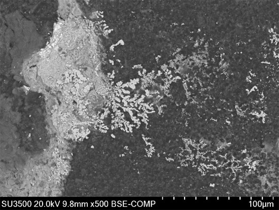 Figure 13. SEM photomicrograph showing electromigration of Ag related to an MLCC Failure.