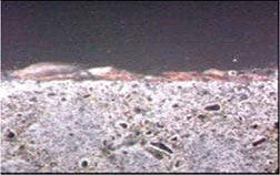 Figure 26. Cross-sectional view of a surface mount IND, post high humidity exposure, showing surface rust.